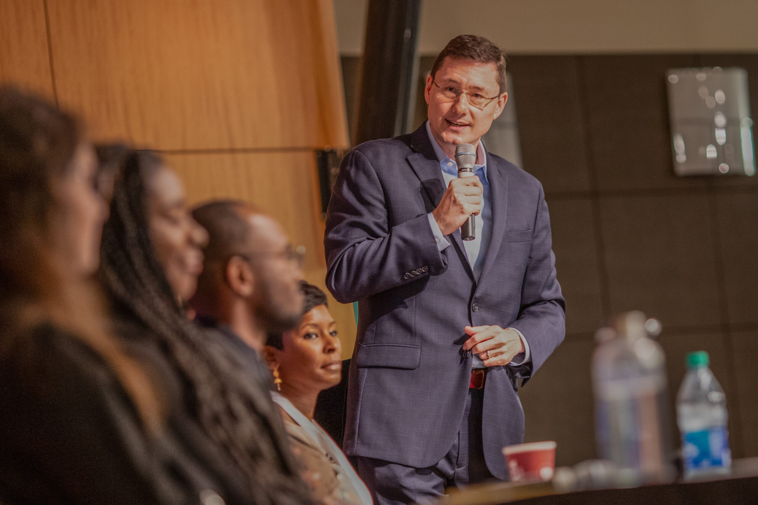 Dr. Tim Jansa higher education consultant and certified coach presenting to an audience and leading panel dscussion